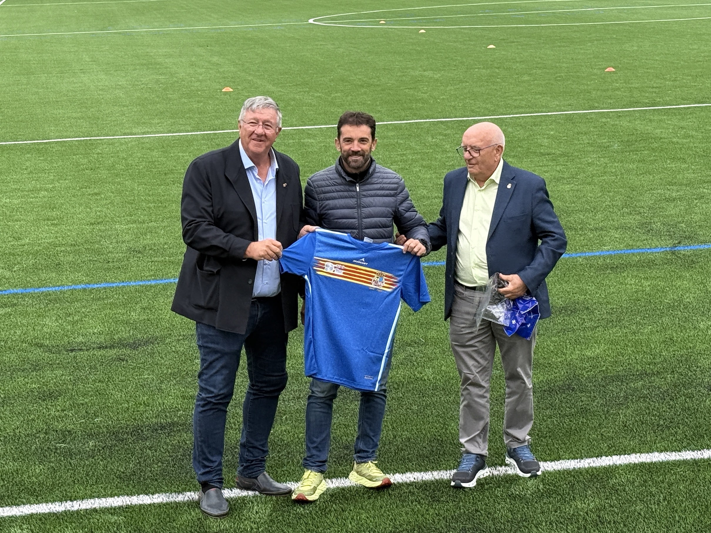 Villa de Ainsa - Sobrarbe Pirineo Aínsa estrena su campo de fútbol de césped artificial tras una inversión municipal de 622.000 euros y 45 años de historia 3 Villa de Ainsa - Sobrarbe Pirineo Directivos de la Federacion le entregan al alcalde una camiseta del centenario como obsequio al ayuntamiento